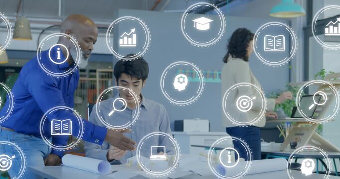 Animation of multiple digital icons against two diverse men discussing at office