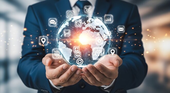Businessman holding a glowing digital globe with icons