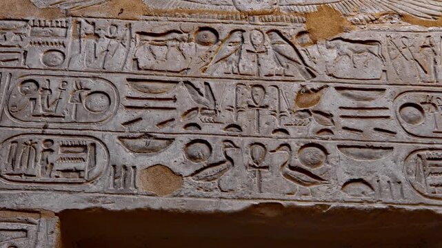 Close-up of detailed hieroglyphic rows with cartouches carved in stone lintel at Seti I temple Luxor Egypt.