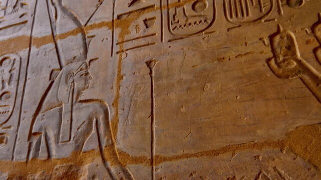 Close-up of detailed hieroglyphic rows with cartouches carved in stone lintel at Seti I temple Luxor Egypt.