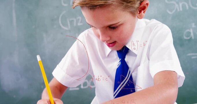 Boy writing math problem on school desk initiating shape animations visualizing math concepts