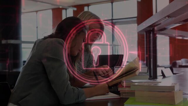 Two women studying for exam at table, red lock graphic appearing over pair while taking notes