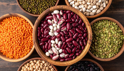 Fototapeta premium Explore a vibrant array of healthy legumes in rustic wooden bowls. Perfect for plantbased nutrition concepts, organic cooking blogs, and showcasing various sustainable protein sources.
