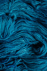 Fototapeta premium Detailed close-up of dark teal wool yarn texture, messy and soft fibers, rich abstract background for handmade and cozy design concepts
