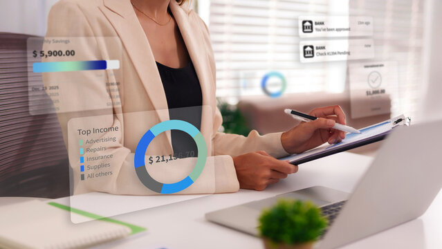 Businesswoman analyzing financial data on an augmented reality interface for budgeting income and managing savings with modern financial technology data analysis investment