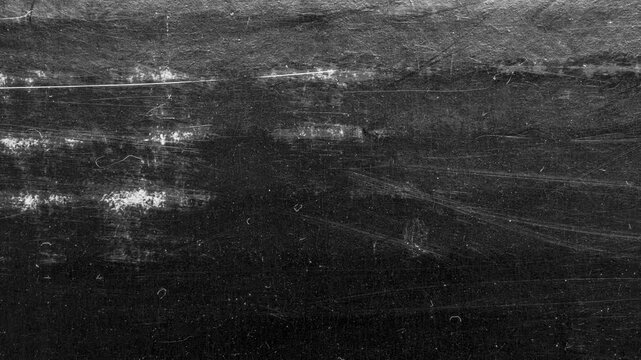 Black scratched grunge texture background, distressed paper surface with white dust and grain