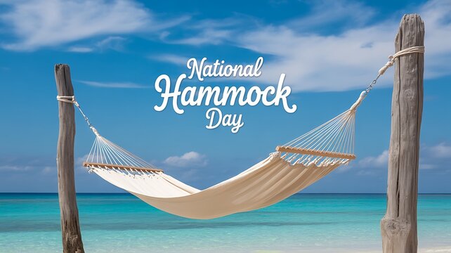 Empty white hammock on a tropical beach with clear blue ocean and sky