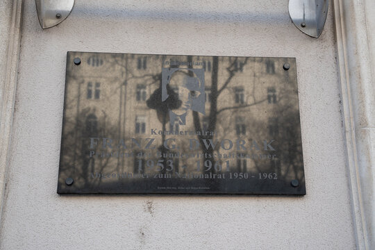 Vienna, Austria- Feb 21, 2026: A memorial plaque dedicated to Franz G. Dvorak, highlighting his contributions from 1953 to 1961, set against a historical backdrop of the city.