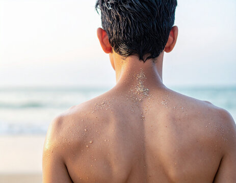 Man back with sand on skin at beach 海辺で背中に砂のある男性