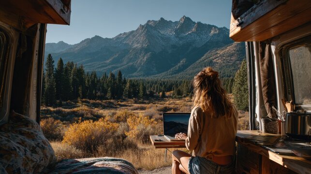 Young Woman Freelancing From a Van With Mountain View in the Background During Daylight in a Natural Setting Enjoying Adventure and Flexibility
