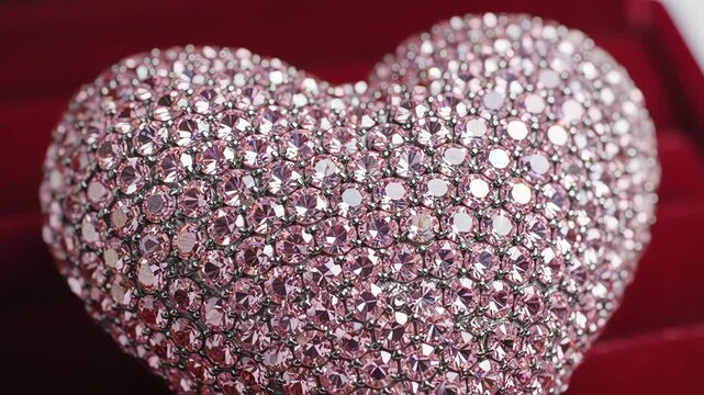 Closeup of a heartshaped object covered in sparkling pink crystals