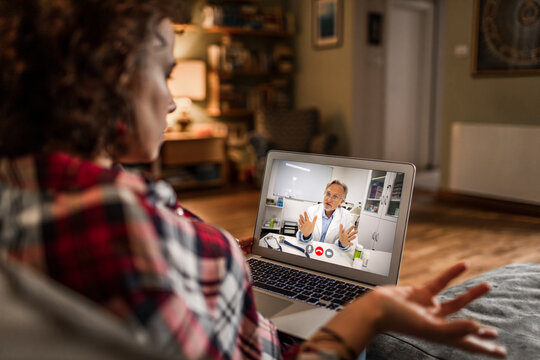 Woman on laptop telemedicine consultation with doctor at home