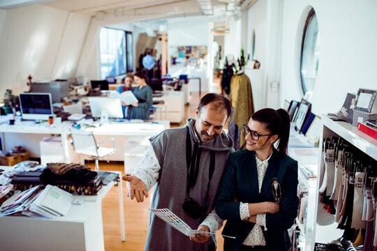 Designers reviewing color swatches in modern fashion studio