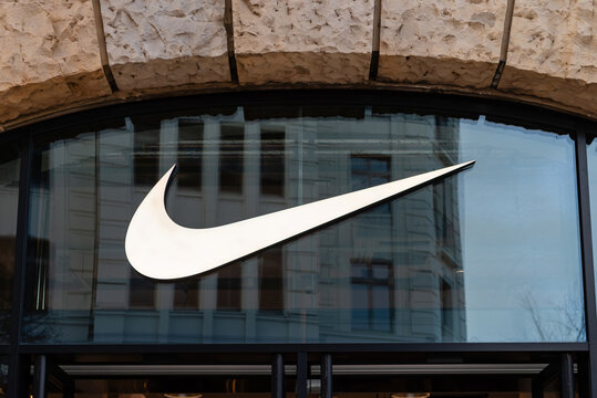 HAMBURG, GERMANY - MARCH 07, 2026: Large Nike brand swoosh logo on a glass store window under a stone arch in downtown Hamburg