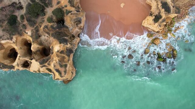 Aerial view of sandy beach and ocean with beautiful clear turquoise water.