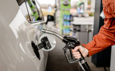 Man'S Hand Holding Diesel Nozzle To Car
