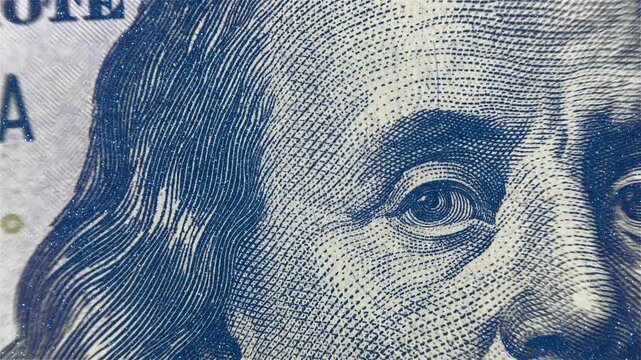 Texture of surface and detail of printing of the main elements of a hundred dollar bill. Added additional paper surface texture. Macro. Closeup. Shot in motion. Shallow depth of field