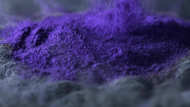 Purple powder explosion forming abstract vibrant pattern concept. Vibrant purple powder explosion with dynamic motion on dark surface for creative abstract background