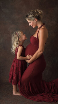 Pregnant mother and daughter bonding, anticipating new baby, embracing family and motherhood concept