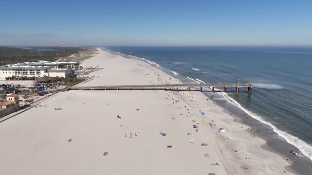 Large sandy beach at St Augustine beach pier near Anastasia State Park in St Augustine, Florida.