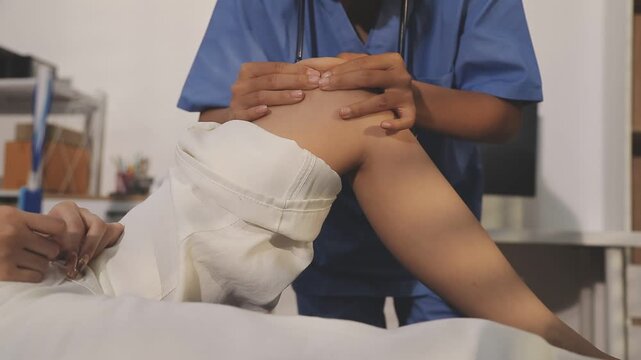 physiotherapist exam patient's knee. Senior patient with knee injury visit his physiotherapist