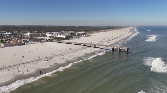 Aerial still shot overlooking St Augustine beach pier near Anastasia State Park in St Augustine, Florida.