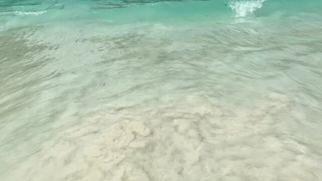 Turquoise ocean waves rolling on a tropical beach in Thailand, beautiful sea water color background.