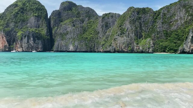 Scenic landscape of Maya Bay Thailand with turquoise water and steep forested cliffs, iconic tropical destination.