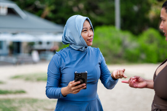 Multiracial women engage in conversation at the beach