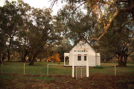 Historic St Mark's country church nestled amongst eucalyptus trees at sunset