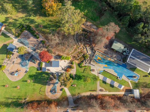 Aerial view of a colourful park playground in a country town