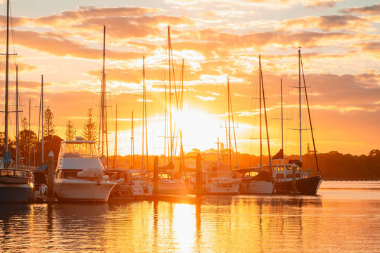 Golden hour sunset at Yamba marina filled with sailboats and yachts