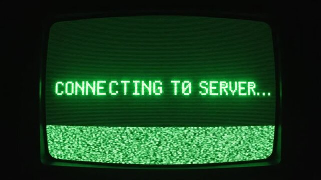 Close-up. Old computer terminal screen. 'CONNECTING TO SERVER...' green pixelated text with heavy CRT scanline distortion. Retro technology cyberpunk hacking.