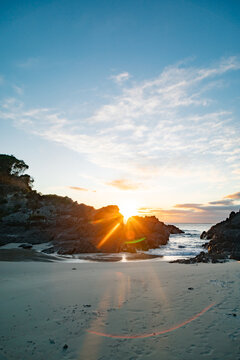 Sun rays bursting through Hedgehog Island at Seal Rocks