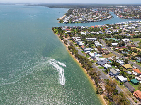 Aerial view of power boats along a coastline waterfront
