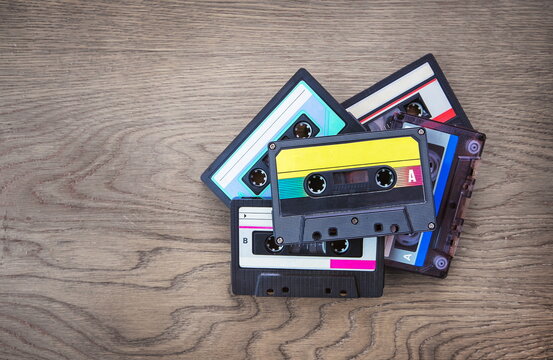 audio cassettes lying on a wooden background