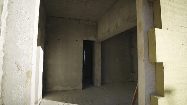 Concrete panel walls inside incomplete condominium building. Visiting new residential enclosure in future residential complex. Housing project