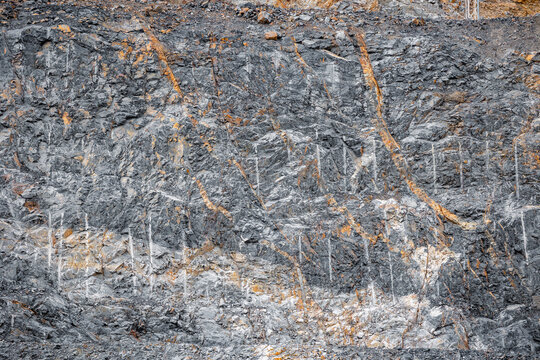 Geological Strata Layers Revealing Erosion Patterns in Rocky Terrain from open pit mine industry.