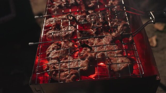 Camping grill flip reveals hot coals and ember glow, grate lifted to expose red charcoal, skewers and tongs in motion, smoky aroma and sizzling meat, energetic outdoor cookout sequence