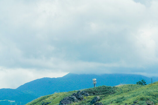 Mountainous landscape in New Taipei, Taiwan, featuring rolling green hills and misty peaks.