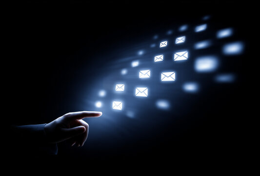 a hand try to interact with multiple e-mail icon