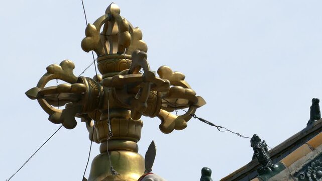 Decoration of the roof of the Mongolian temple in the form of a sacred Buddhist symbol on the background of the blue clear sky. Mongolia, Erdene Zuu monastery.