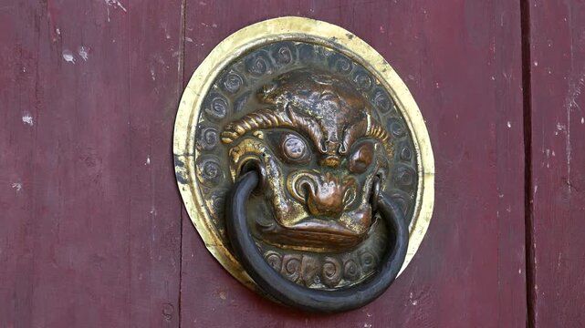 Decoration of the gate of the ancient Buddhist monastery in the form of the head of the fantastic lion-guardian. Erdene Zuu monastery, Kharkhorin, Mongolia.