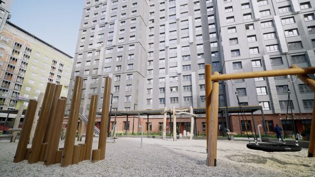 Sustainable wooden playground features natural logs over crushed stone. Eco-friendly design provides safe space for energetic children
