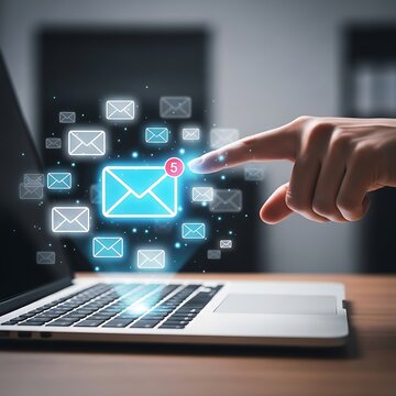 A hand interacting with a glowing email icon on a laptop screen with various app icons floating around