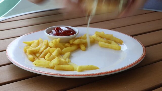 Eating a Deep Fried Fish Burger and French Fries