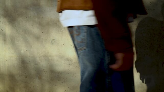 Abstract A man Silhouettes and Shadows Swaying on a Vintage Concrete Wall with Natural Sunlight