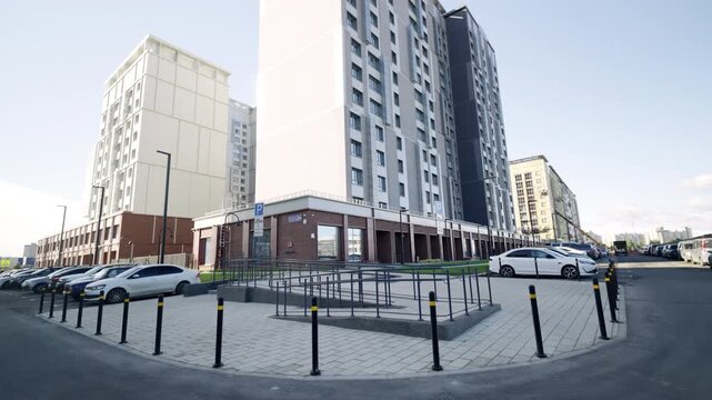 Parking lots and store near multistory apartment buildings on summer day. Urban conveniences for tenants of modern dwelling block