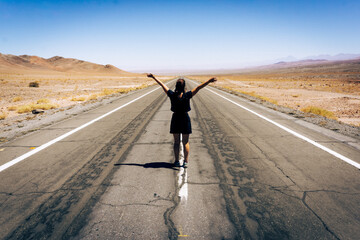 Obraz premium Woman walking alone on desert road, freedom and travel concept in Atacama landscape Chile