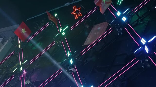 A night street with bars, restaurants, dance clubs, strip bars, casinos and other entertainment venues, where brightly colored spotlights shine and neon signs attract visitors and advertising